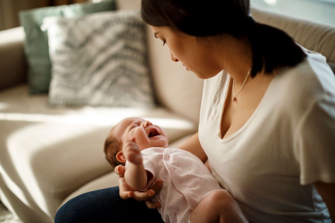 Newborn baby crying in mother hands