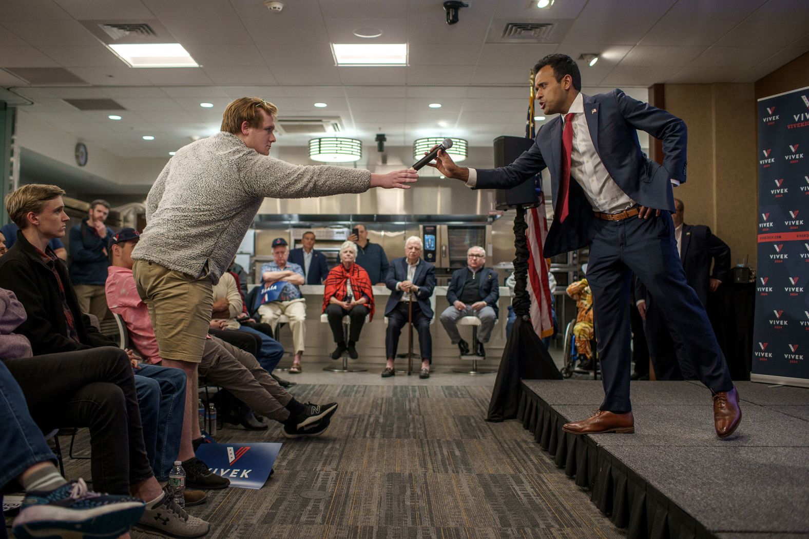 Ramaswamy hands the microphone to Walter Waligura for a question during a campaign event in Windham, New Hampshire, in May 2023.
