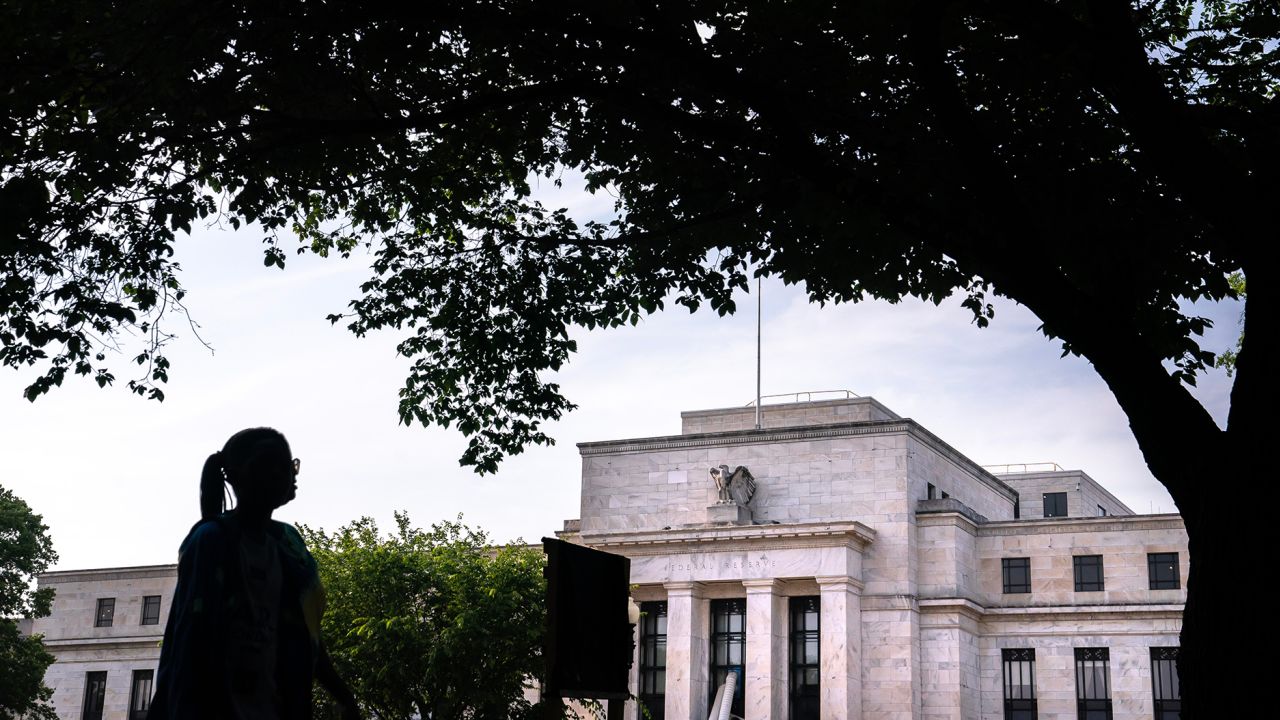 A pedestrian passes the Marriner S. Eccles Federal Reserve building in Washington, DC, US, on Saturday, June 3, 2023. 