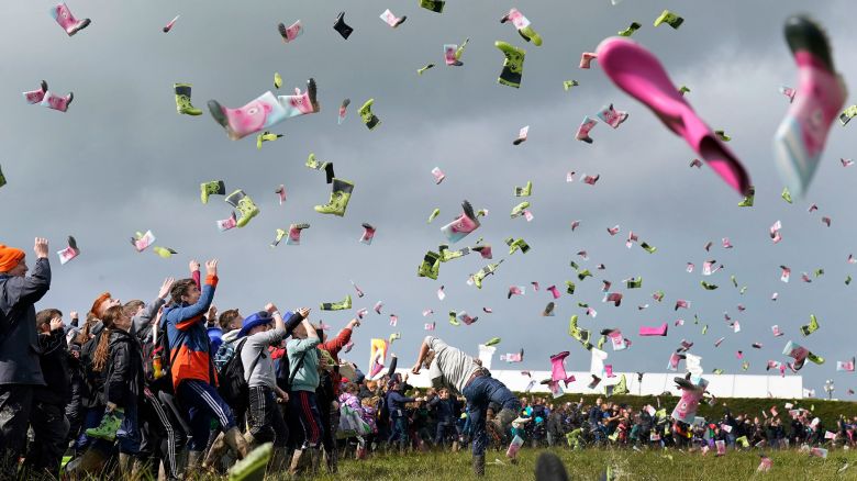 Nine hundred and ninety-five people take part in a Guinness World Record attempt at the most people throwing wellies organized by Youth farming group Macra on day 2 of the National Ploughing Championships at Ratheniska, Co Laois, Ireland, Wednesday Sept. 20, 2023. (Niall Carson/PA via AP)