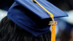 FILE - A tassel with 2023 on it rests on a graduation cap as students walk in a procession for Howard University's commencement in Washington, Saturday, May 13, 2023. The Supreme Court is getting ready to decide some of its biggest cases of the term, including the fate of President Joe Biden's plan to wipe away or reduce student loans held by millions of Americans. (AP Photo/Alex Brandon, File)