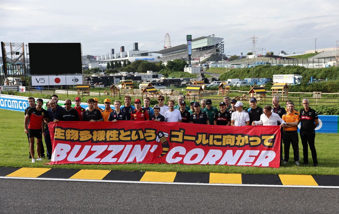 Formula One F1 - Japanese Grand Prix - Suzuka Circuit, Suzuka, Japan - September 21, 2023
Former driver Sebastian Vettel poses with drivers and team members as he launches 'Buzzin' Corner' a project to raise awareness about the importance of biodiversity REUTERS/Issei Kato