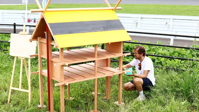 SUZUKA, JAPAN - SEPTEMBER 21: Sebastian Vettel builds bee hives around the circuit during previews ahead of the F1 Grand Prix of Japan at Suzuka International Racing Course on September 21, 2023 in Suzuka, Japan. (Photo by Clive Rose/Getty Images)