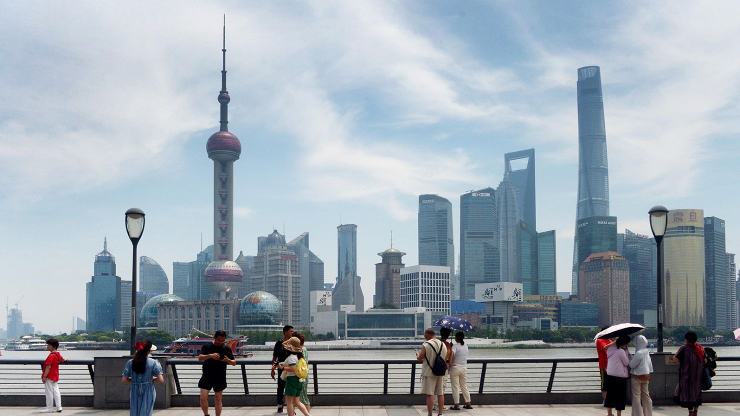 Tourists look out onto the Lujiazui financial district in Shanghai, which is part of the city's pilot free trade zone and home to hundreds of banks and financial service firms.