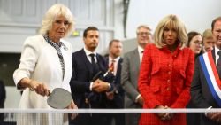 PARIS, FRANCE - SEPTEMBER 21: Queen Camilla reacts as she plays table tennis as Brigitte Macron, wife of French President Emmanuel Macron watches as they meet local youth sports associations in Saint-Denis near Paris on September 21, 2023 in Paris, France. The King and The Queen's first state visit to France will take place in Paris, Versailles and Bordeaux from Wednesday 20th to Friday 23rd 2023. The visit had been initially scheduled for March 26th - 29th but had to be postponed due to mass strikes and protests (Photo by Hannah McKay-Pool/Getty Images)