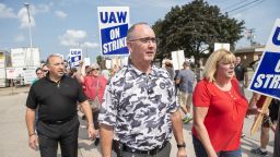 UAW president Shawn Fain and members and workers at the Mopar Parts Center Line, a Stellantis Parts Distribution Center in Center Line, Michigan, picket outside the facility after walking off their jobs at noon on September 22, 2023. The US auto workers union expanded a potentially economically and politically damaging strike against two of Detroit's "Big Three" on September 22, 2023 -- and invited President Joe Biden to support workers on the picket line. UAW President Shawn Fain announced a strike of all 38 US parts and distribution centers at General Motors and Stellantis, where negotiations are stalled. 