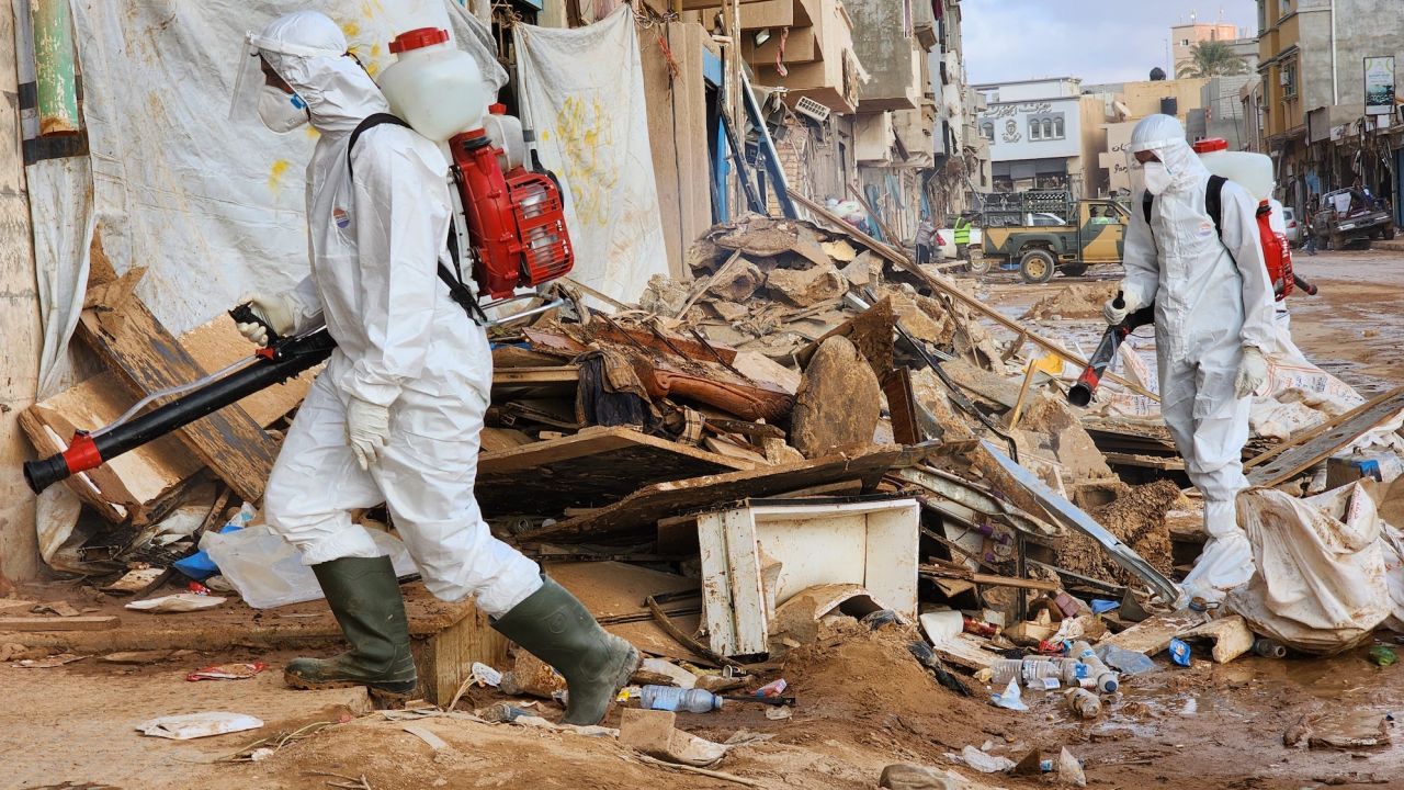 Local teams spray damaged streets with chemical disinfectants following warnings about a secondary health crisis.