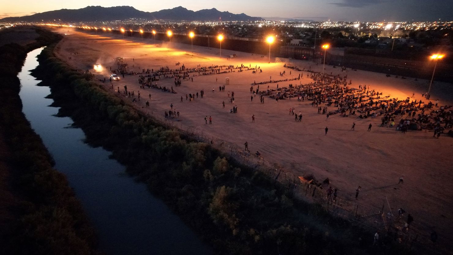 Migrants gather near the border wall after crossing the Rio Bravo river with the intention of turning themselves in to the US Border Patrol agents to request asylum, as seen from Ciudad Juarez, Mexico, on September 22, 2023.