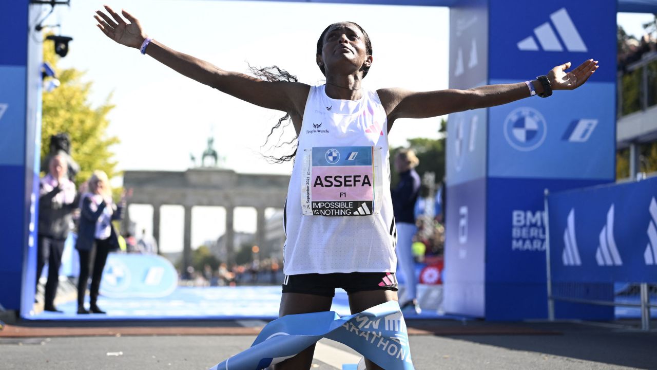 Ethiopia's Tigist Assefa celebrates after smashing the women's marathon world record by crossing the finish line to win the women's race of the Berlin Marathon on September 24, 2023 in Berlin, Germany. (Photo by Tobias SCHWARZ / AFP) (Photo by TOBIAS SCHWARZ/AFP via Getty Images)