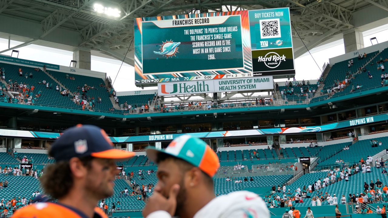Miami Dolphins quarterback Tua Tagovailoa, right, talks to Denver Broncos quarterback Jarrett Stidham  after Sunday's demolition in Miami Gardens, Florida.
