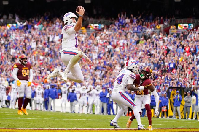 Buffalo Bills quarterback Josh Allen leaps into the end zone for a touchdown during his team's 37-3 win over the Washington Commanders on September 24. 