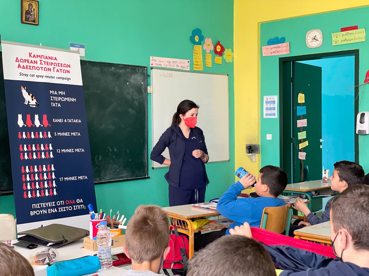 18.	Dr. Anna Katogiritis speaks to elementary school students about stray animals and the importance of spay/neuters during a community outreach event in 2022 on Karpathos island, Greece.