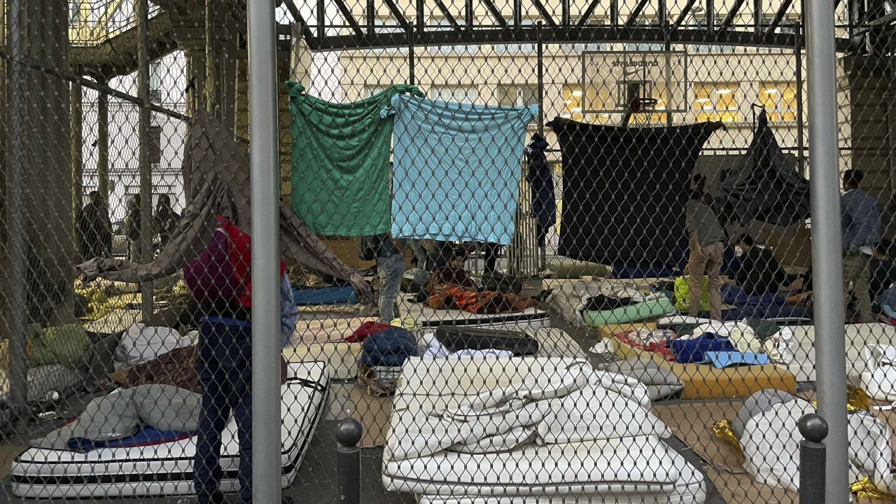 Homeless people sleep on old mattresses and cardboard under the Stalingrad Métro station in the northeast of Paris.