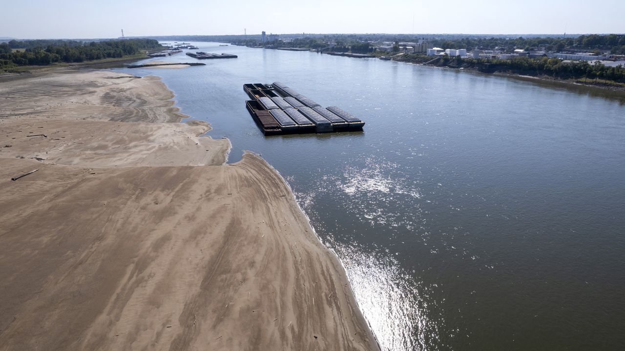 Barges float in the Mississippi River as a portion of the riverbed is exposed on September 15 in St. Louis. 