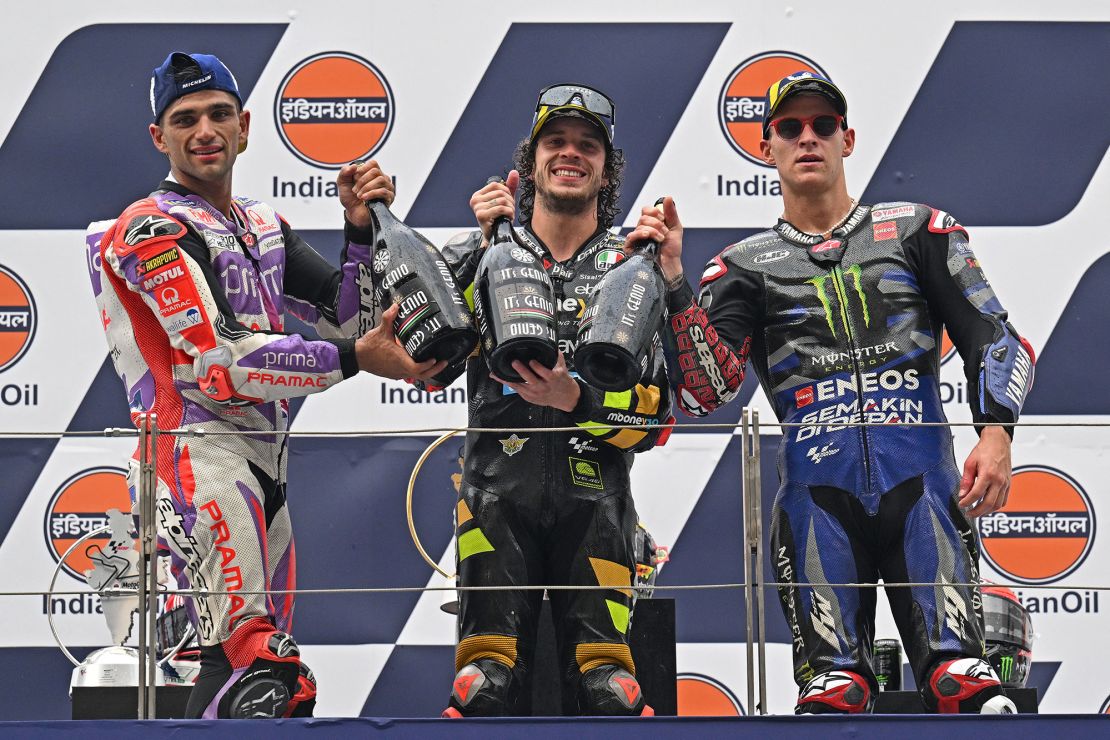 First-placed Bezzecchi (C), second-placed Prima Pramac Racing's Spanish rider Jorge Martin (L) and third-placed Monster Energy Yamaha's French rider Fabio Quartararo pose on the podium after the Indian MotoGP Grand Prix.