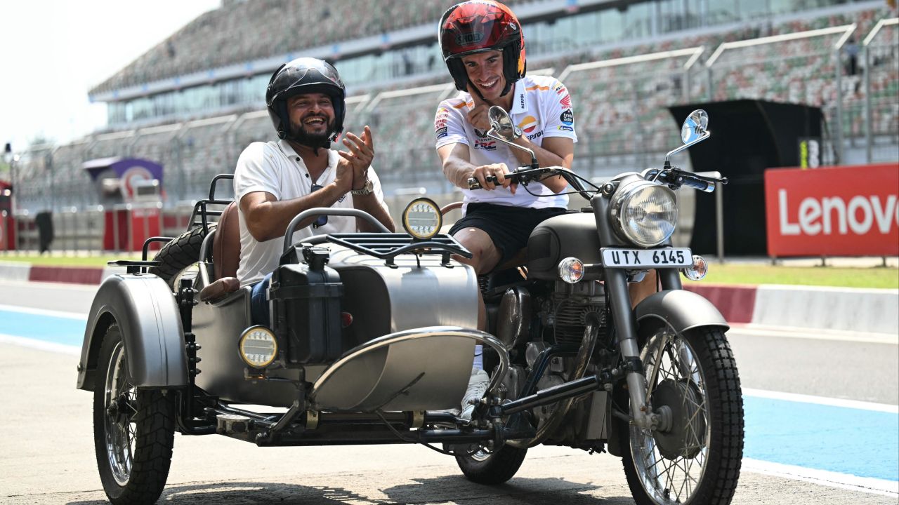 Repsol Honda's Spanish rider Marc Marquez (R) and India's former cricket player Suresh Raina ride on a motorbike ahead of the Indian MotoGP Grand Prix at the Buddh International Circuit in Greater Noida on the outskirts of New Delhi, on September 21, 2023.