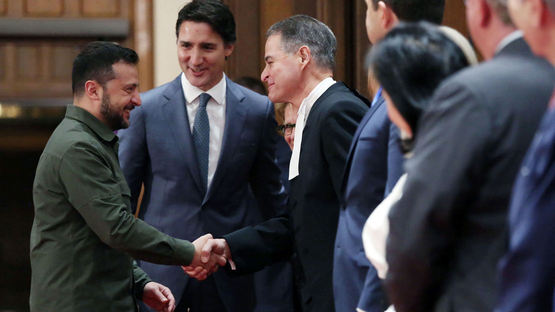 Ukrainian President Volodymyr Zelensky shakes hands with House of Commons Speaker Anthony Rota as Prime Minister Justin Trudeau looks on last Friday in Ottawa.