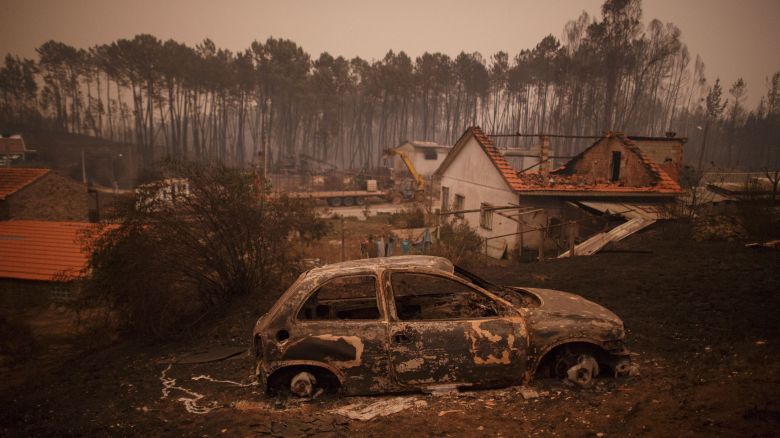 LEIRIA, PORTUGAL - JUNE 18:  A burned car stand next to burned houses after a wildfire took dozens of lives on June 18, 2017 near Castanheira de Pera, in Leiria district, Portugal. On Saturday night, a forest fire became uncontrollable in the Leiria district, killing at least 62 people and leaving many injured. Some of the victims died inside their cars as they tried to flee the area.  (Photo by Pablo Blazquez Dominguez/Getty Images)