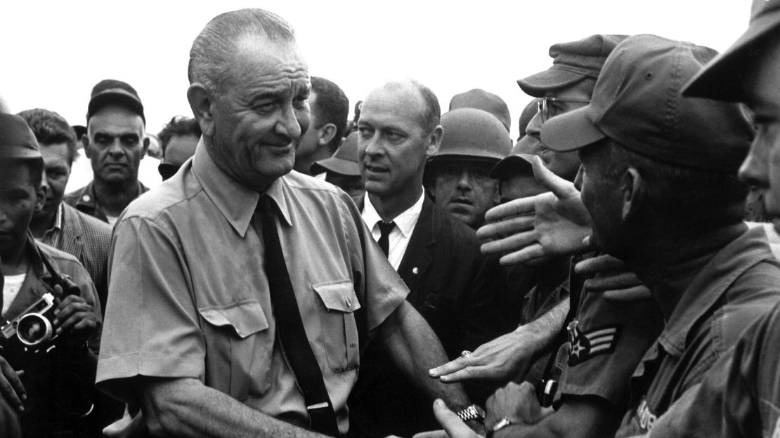 Johnson shakes the hands of soldiers as he visits American troops in Vietnam in 1966.