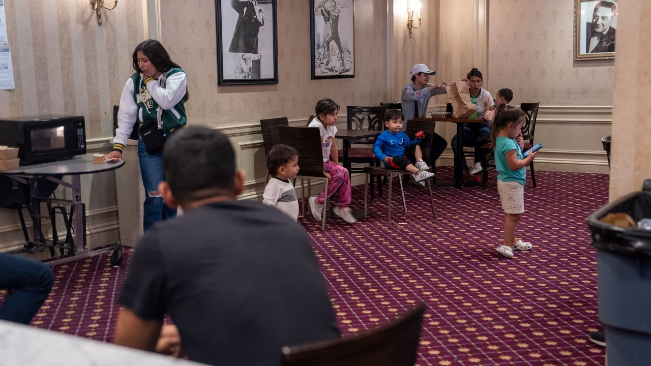 Children play and eat under pictures of President Theodore Roosevelt, after whom the hotel was named, and bandleader Guy Lombardo, on September 20, 2023.