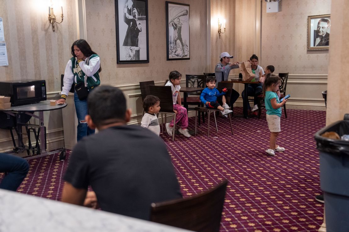 Children play and eat under pictures of President Theodore Roosevelt, after whom the hotel was named, and bandleader Guy Lombardo, on September 20, 2023.
