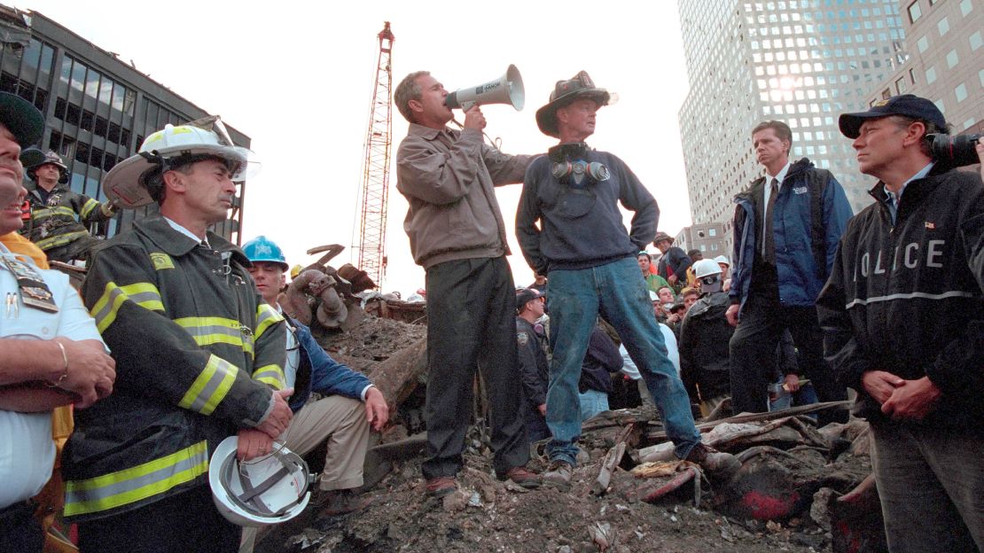 Bush stands atop a crumpled fire truck with retired New York City fireman Bob Beckwith on September 14, 2001.