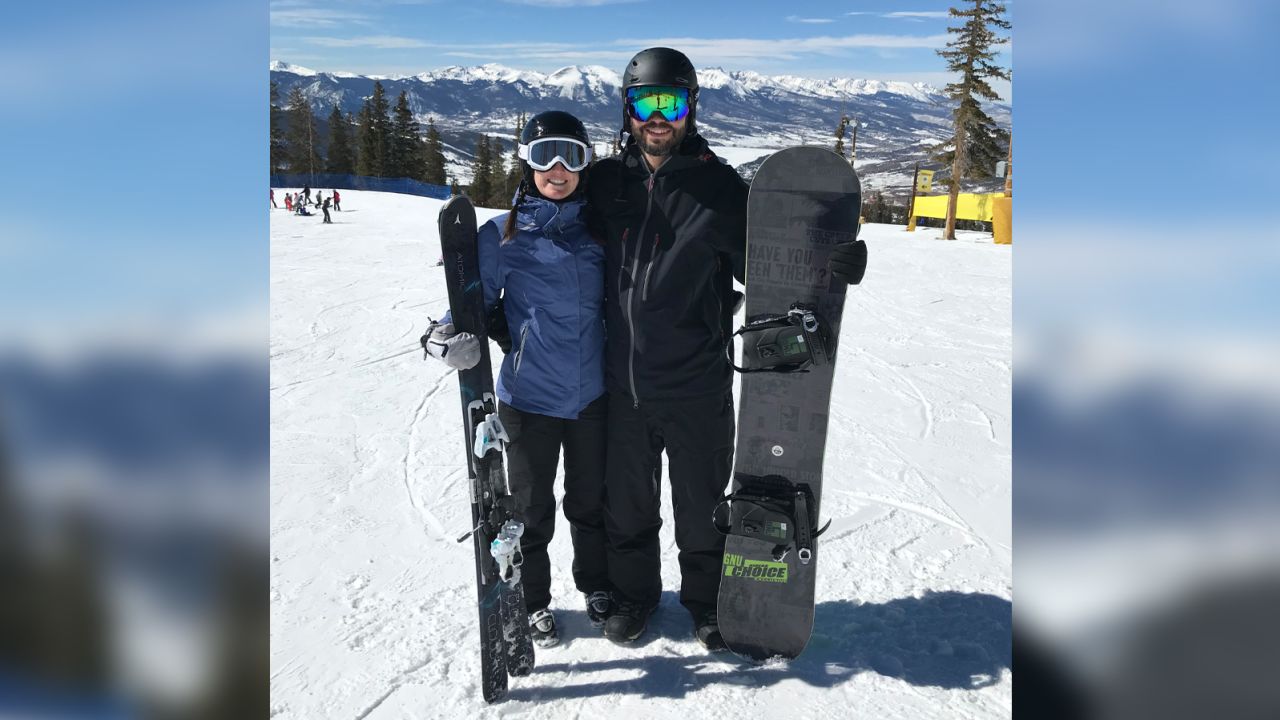 Alexandra and Shawn smile for a photo at a ski resort in March 2018.
