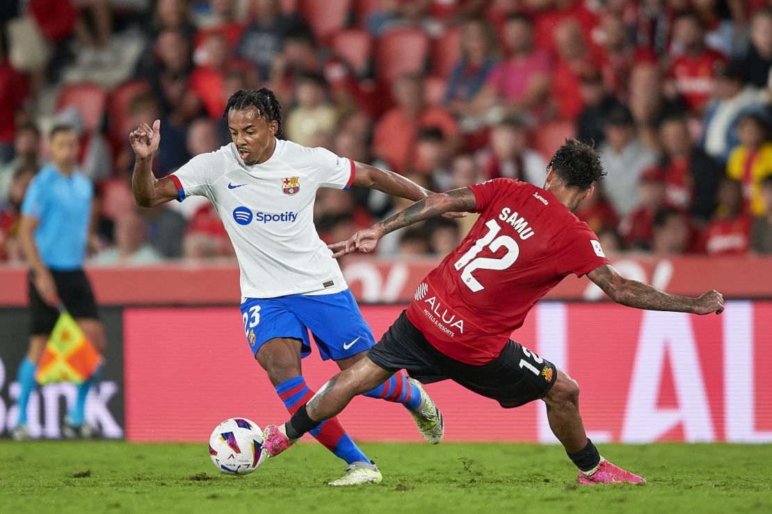MALLORCA, SPAIN - SEPTEMBER 26: Samu Costa of RCD Mallorca competes for the ball with Jules Kounde of FC Barcelona during the LaLiga EA Sports match between RCD Mallorca and FC Barcelona at Estadi de Son Moix on September 26, 2023 in Mallorca, Spain. (Photo by Cristian Trujillo/Quality Sport Images/Getty Images)