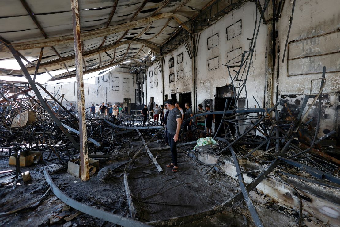 Locals can be seen walking through the debris of a wedding hall destroyed by a fire in Qaraqosh, in northern Iraq, on September 27.