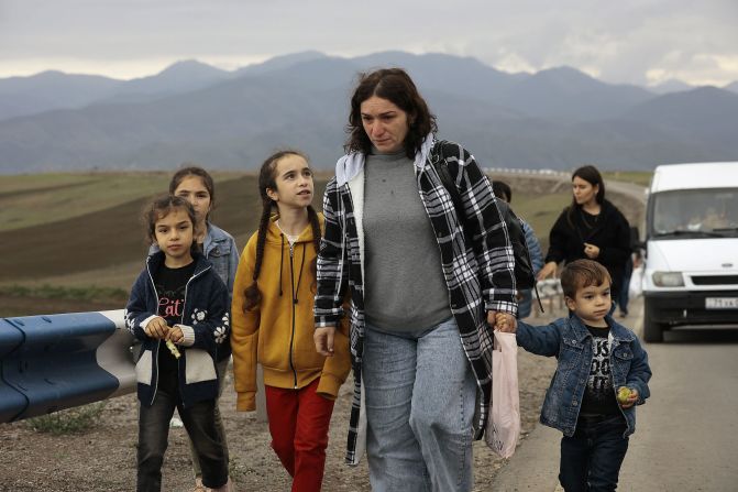 Ethnic Armenians from Nagorno-Karabakh walk along the road leading to Kornidzor, where a humanitarian hub has been created, on September 26.