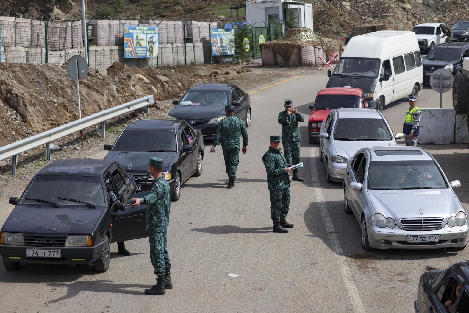 Azerbaijani soldiers conduct traffic as cars line up to leave for Armenia on September 26.