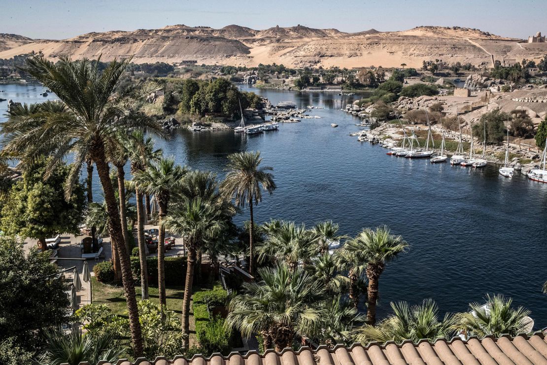 This picture taken on January 3, 2021 shows a view of Aswan from the Old Cataract Hotel overlooking the Nile river in Egypt's southern city of Aswan, some 920 kilometres south of the capital, where British crime fiction writer Dame Agatha Christie is believed to have stayed while writing her 1937 novel "Death on the Nile", with the Mausoleum of Aga Khan III seen in the background (top R). - Over a century since it first cruised the glittering waters of the Nile, the steam ship "Sudan" draws tourists following the trail of legendary crime novelist Agatha Christie, whom it was inspired to pen one of her most famous whodunnits in 1937, "Death on the Nile". (Photo by Khaled DESOUKI / AFP) (Photo by KHALED DESOUKI/AFP via Getty Images)