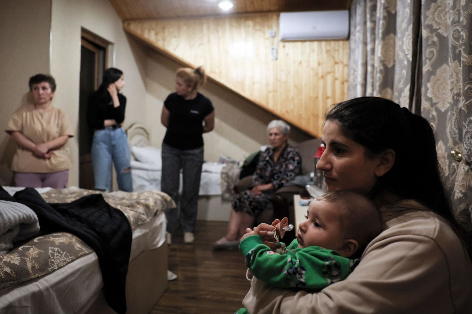 Former Nagorno-Karabakh residents at a hotel room in Goris after crossing the Armenian border on September 26.