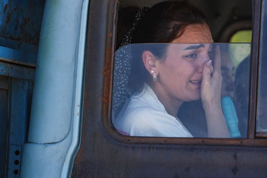 A woman cries after crossing the border near Kornidzor on September 27.