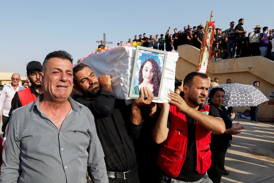 Mourners carry the coffin of a victim during a funeral in Hamdaniya, Iraq, on September 27.