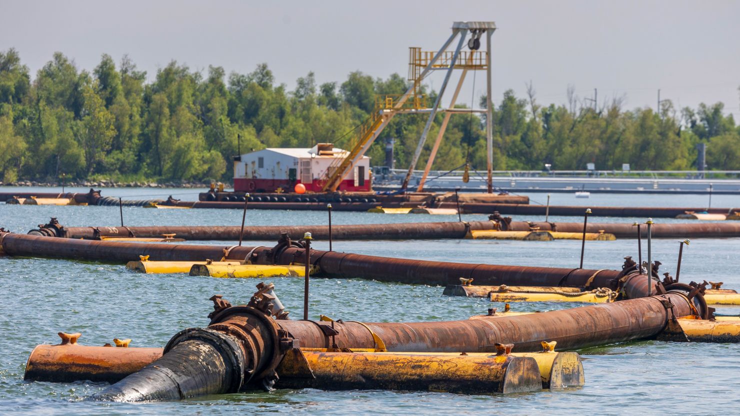 Pipes carrying sediment crisscross the Mississippi River where the US Army Corps of Engineers is building up an underwater sill intended slow the flow of saltwater up the Mississippi River south of New Orleans on Tuesday.