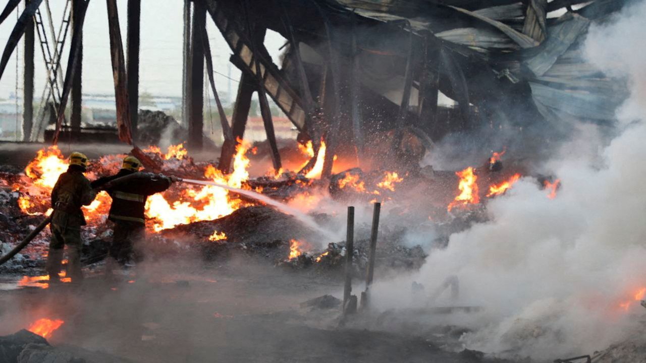 Firefighters work to extinguish a blaze following an explosion at a warehouse near an airport in Tashkent, Uzbekistan.