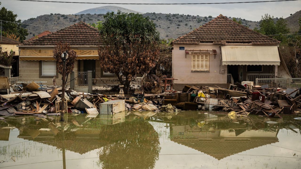 This photograph taken on September 26, 2023 shows damaged houses and debris sitting amongst standing water three weeks after Storm Daniel, in the village of Keramidi, central Greece. The unprecedented storm left 17 dead and devastated the central region of Thessaly, the heart of Greece's agricultural production. The flood drowned tens of thousands of farm animals whilst also sweeping through warehouses containing fertiliser, weedkillers, petrol and other chemicals, leaving behind a toxic floodwater mix. (Photo by Angelos TZORTZINIS / AFP) (Photo by ANGELOS TZORTZINIS/AFP via Getty Images)