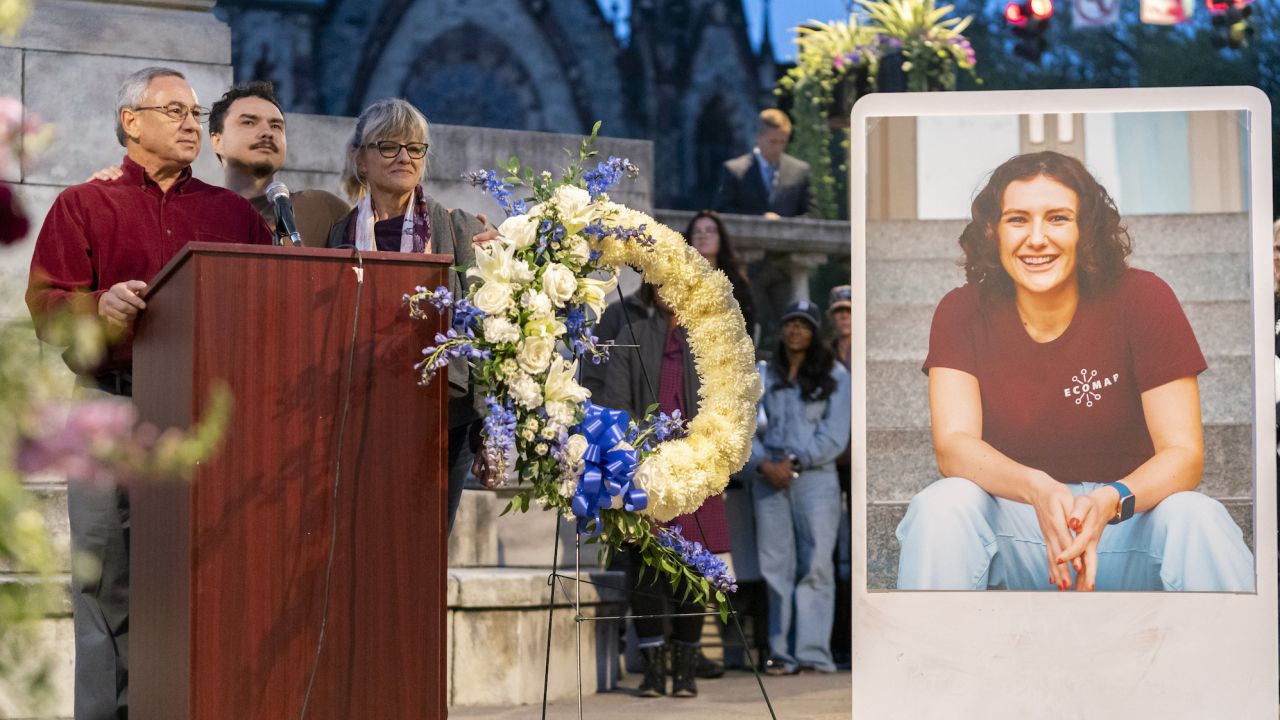 Pava LaPere's father, Frank LaPere, is joined by his wife Caroline and son Nico as he speaks during a vigil on Wednesday.