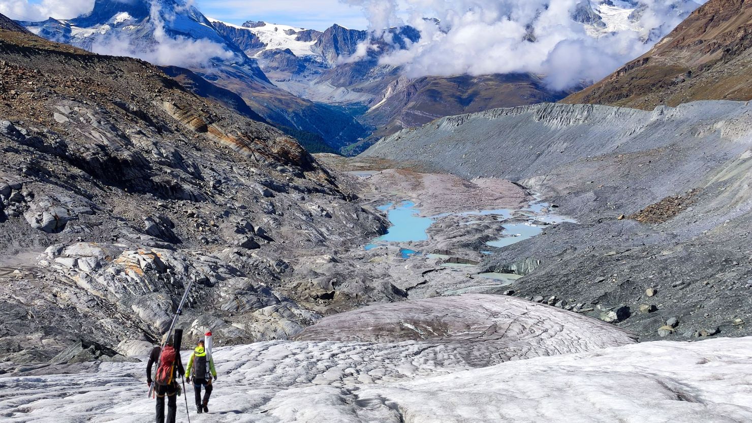 Glaciologists climb over the collapsed tongue of the Findel Glacier (Valais). The radiantly blue glacial lakes were still covered by dozens of metres of ice a decade ago.