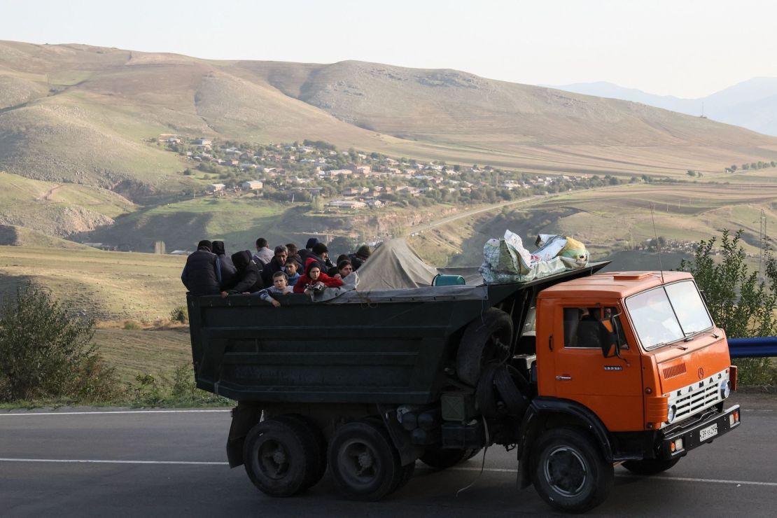 TOPSHOT - A truck with refugees on board rides on the road between Kornidzor and Goris on September 28, 2023. More than 65,000 Armenians have fled Nagorno-Karabakh for Armenia, Yerevan said on September 28, 2023, as the exodus continued from the breakaway enclave which Azerbaijan recaptured last week in a lighting offensive. (Photo by ALAIN JOCARD / AFP) (Photo by ALAIN JOCARD/AFP via Getty Images)