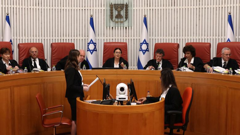 President of the Israeli Supreme Court Esther Hayut (C) and judges assemble to hear petitions against a law that blocks the court from potentially ordering the prime minister to recuse himself from office, at the court premises in Jerusalem on Thursday.