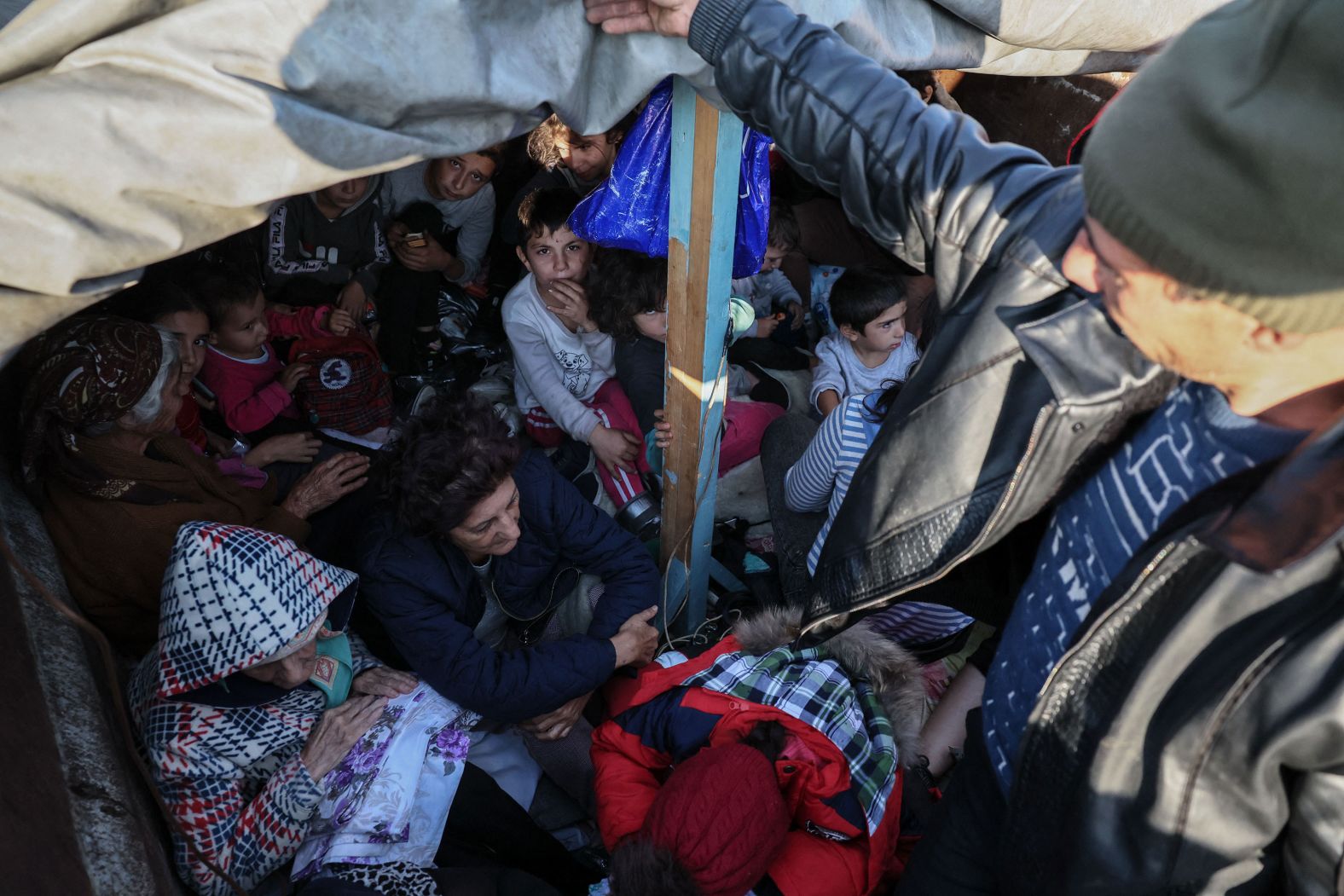 People fleeing Nagorno-Karabakh sit on the back of a truck near Kornidzor on September 28.