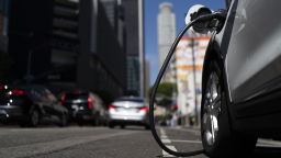 An electric vehicle is plugged into a charger in Los Angeles, Aug. 25, 2022. 