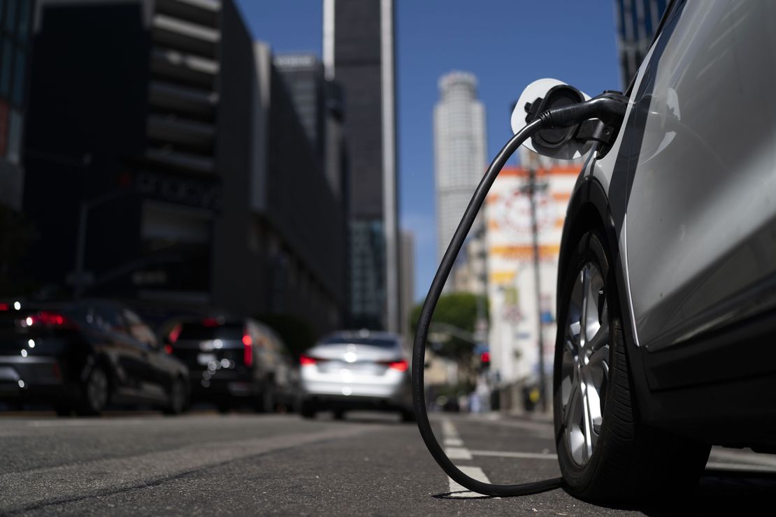 An electric vehicle is plugged into a charger in Los Angeles in August 2022. 