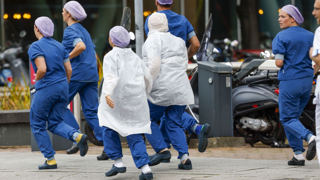 Medical staff leave the hospital following reports of a shooting.