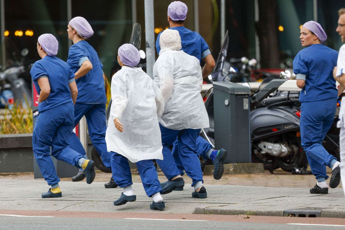 Medical staff leave the hospital following reports of a shooting.