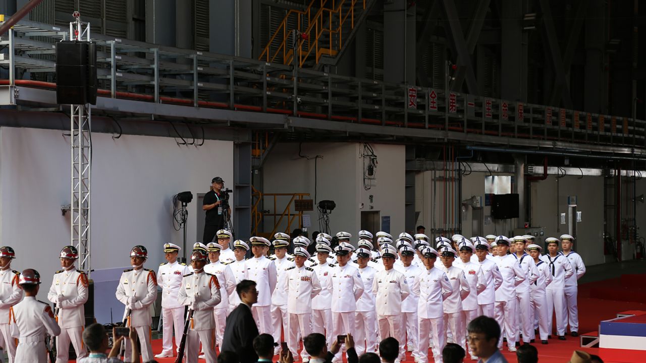 Dozens of naval officers at the submarine's shipyard welcome President Tsai Ing-wen to the launch ceremony in Kaohsiung on September 28.
