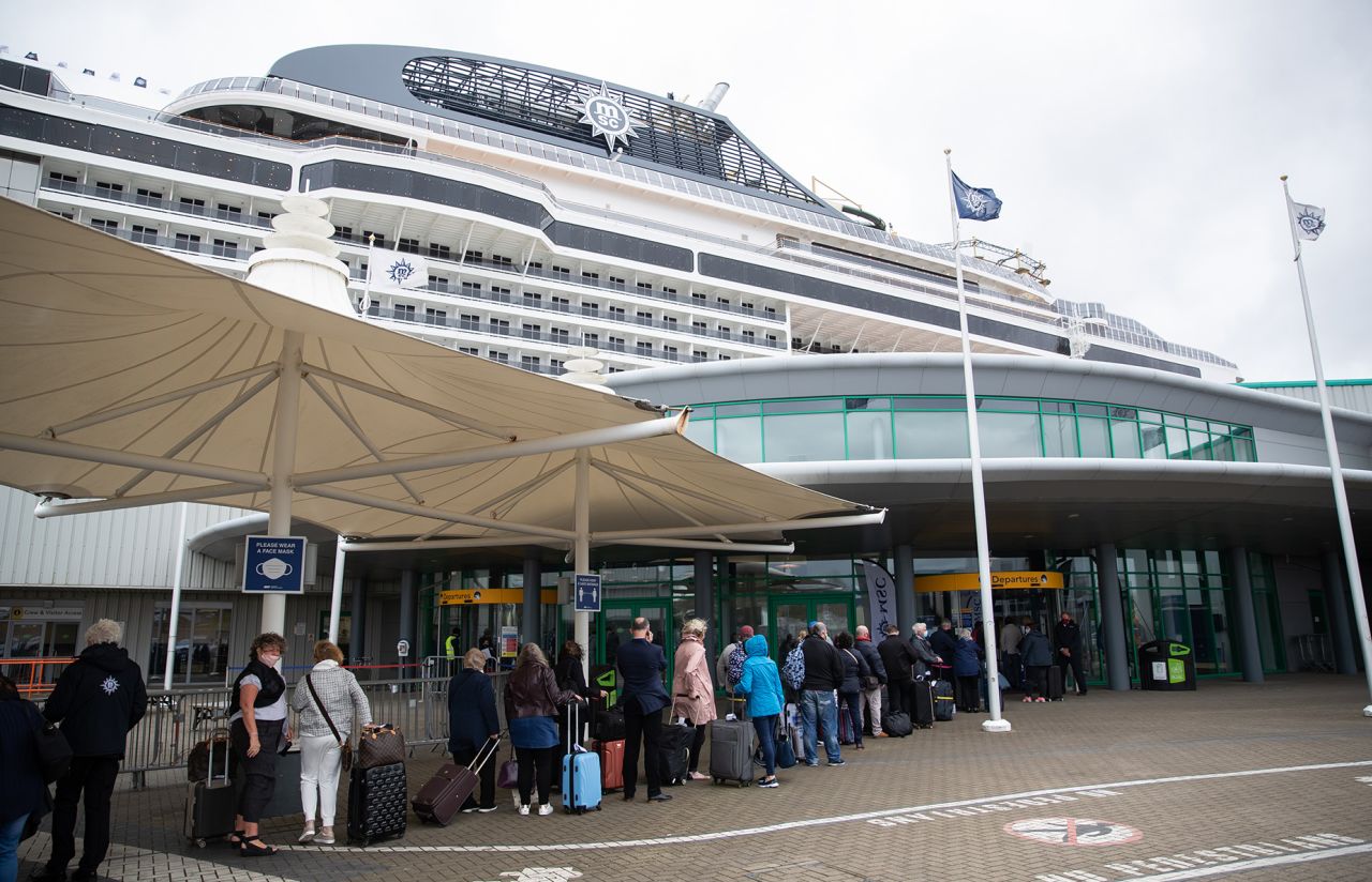 People line up outside the departure lounge at the City Cruise Terminal before boarding the cruise ship MSC Virtuosa as it prepares to depart the Port of Southampton on its first cruise since the easing of restrictions. Picture date: Thursday May 20, 2021. (Photo by Andrew Matthews/PA Images via Getty Images)