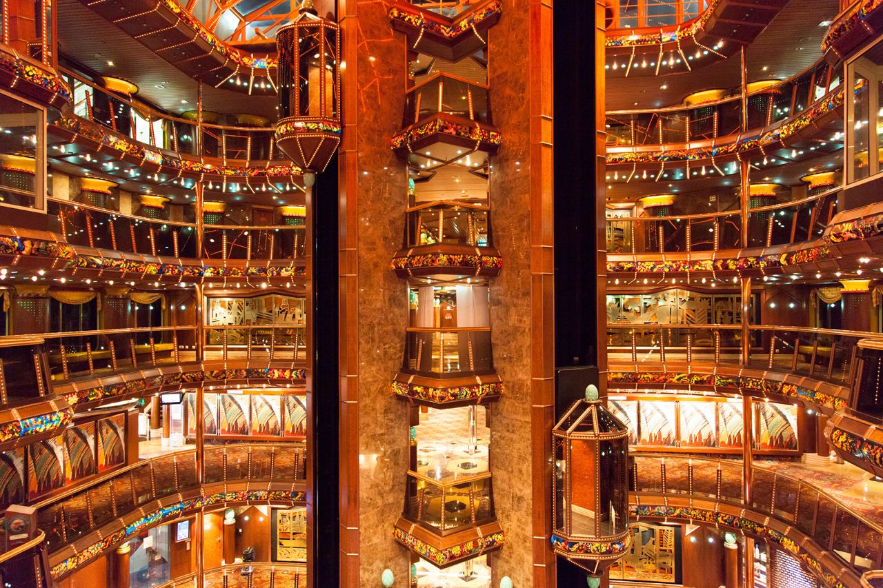 G3RG24 The view of colorful interior of a cruise liner with glass elevators in a middle.